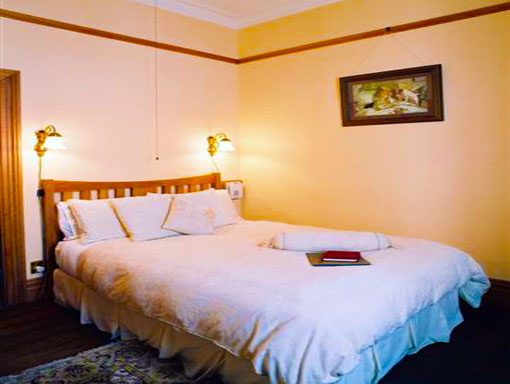 The Jenny Room at Braemar with antique furnishings and a double bed
