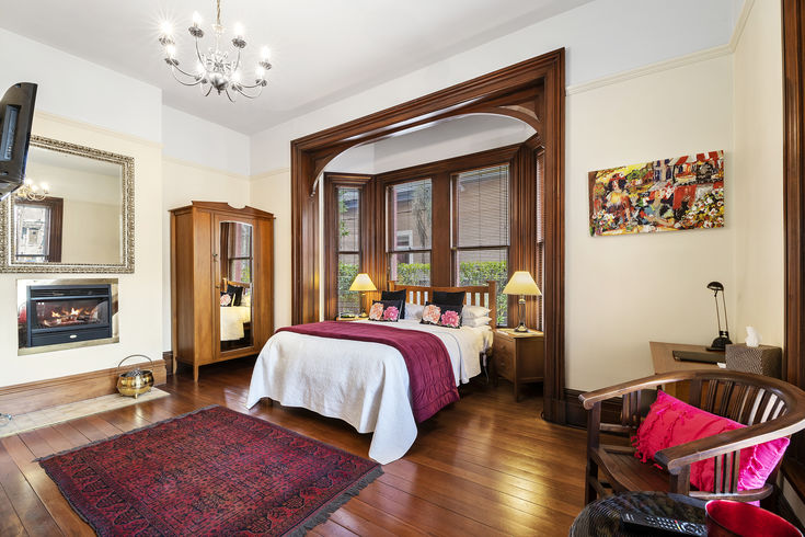 A historical queen room at The Classic Villa