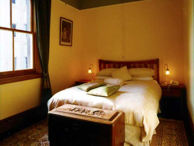 The Norman Room at Braemar with a queen bed and Persian rug