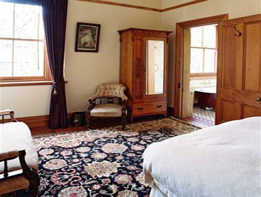 The Batten Suite at Braemar with a queen bed, fireplace and private lounge