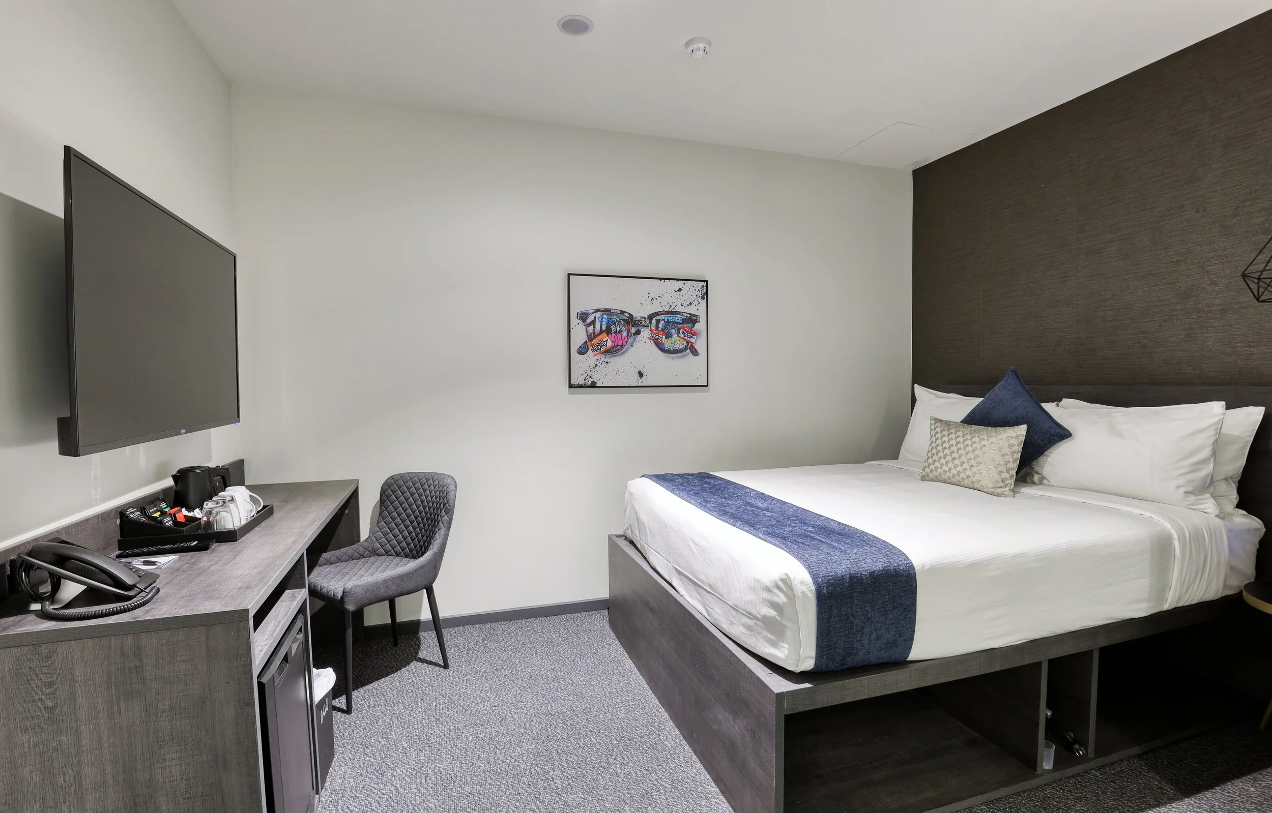 The Viv Hotel Internal Queen Room with a queen bed in a calm, windowless setting