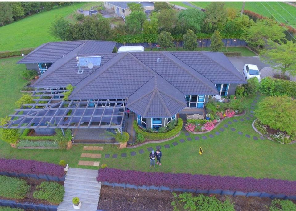 An aerial view of Waitomo Orchard Estate B&B, a country homestead with solar panels near Otorohanga